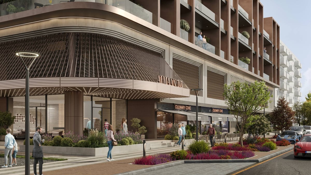 Almaan 101 — The curved canopy brings the residential entrance and street-facing shops into one continuous frontage.