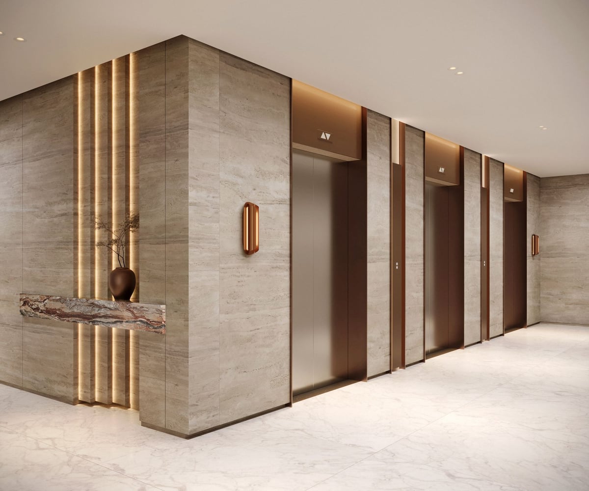 Almaan 101 — Stone surrounds and recessed doors give the lift lobby a quieter rhythm than the reception hall.
