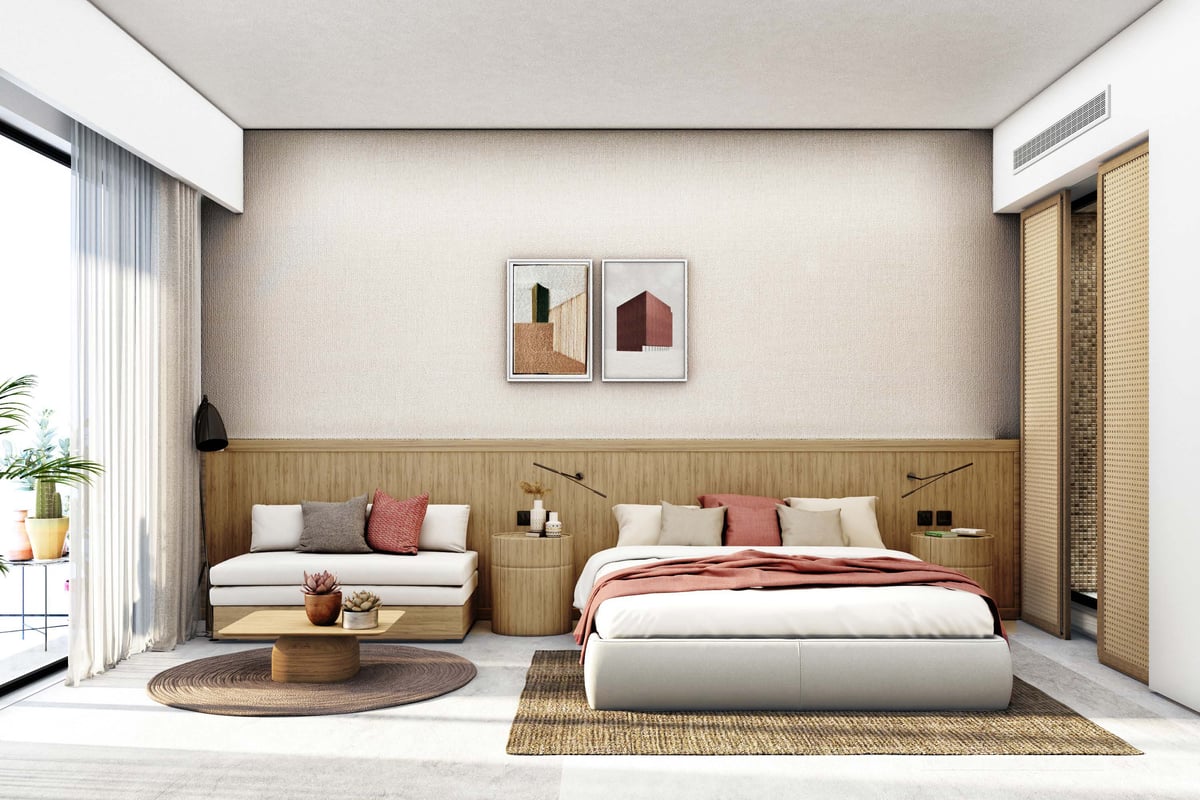 Costa Mares — A continuous timber headboard connects sleeping and sitting areas within the guest room.