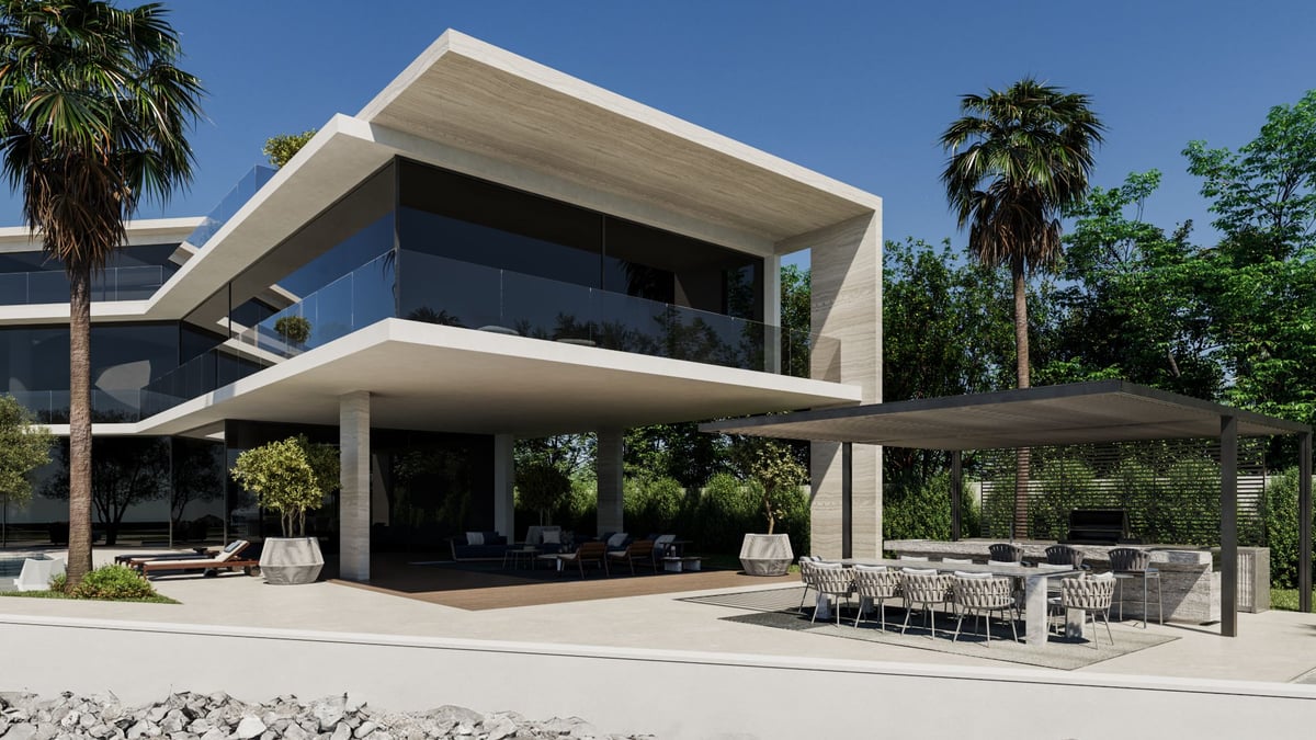 La Mer C1 — The outdoor kitchen sits under a steel pergola beside the pool, with the house's overhang behind.