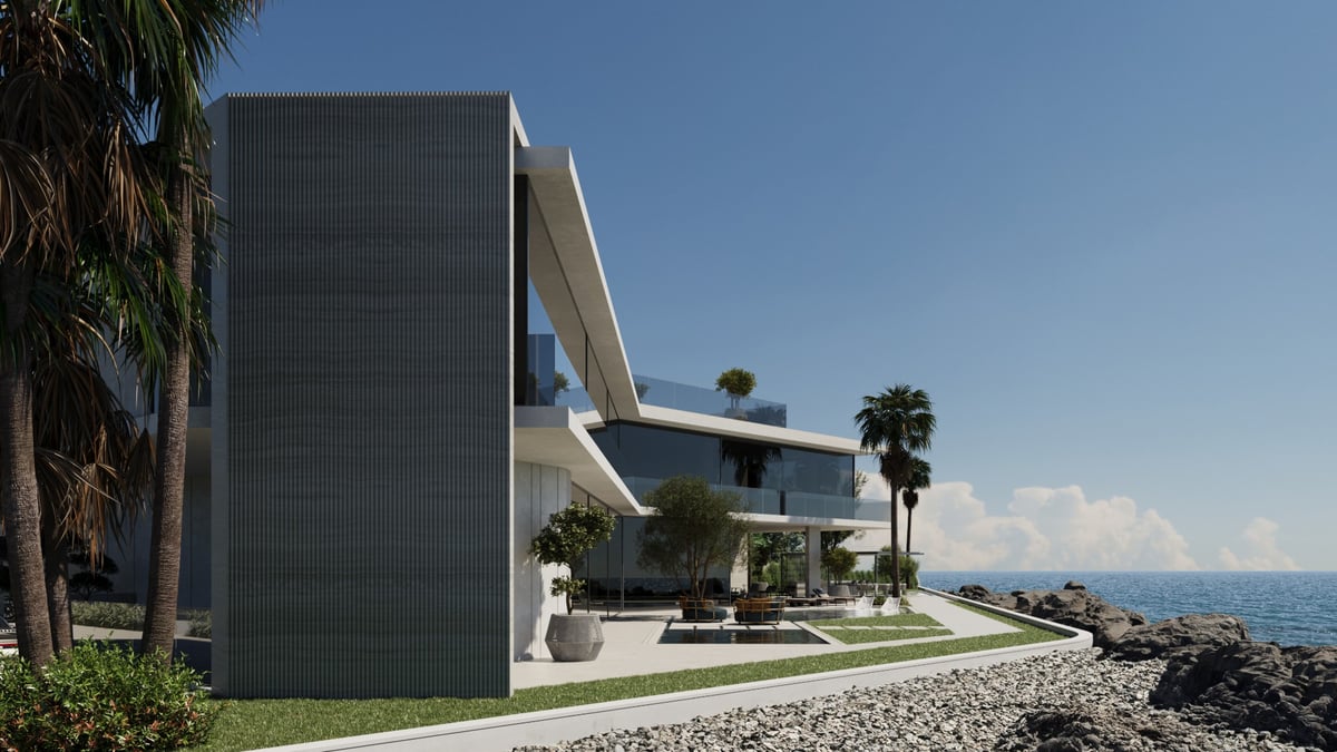 La Mer C1 — The fluted stone fin marks the turn from the closed street front to the open sea side.