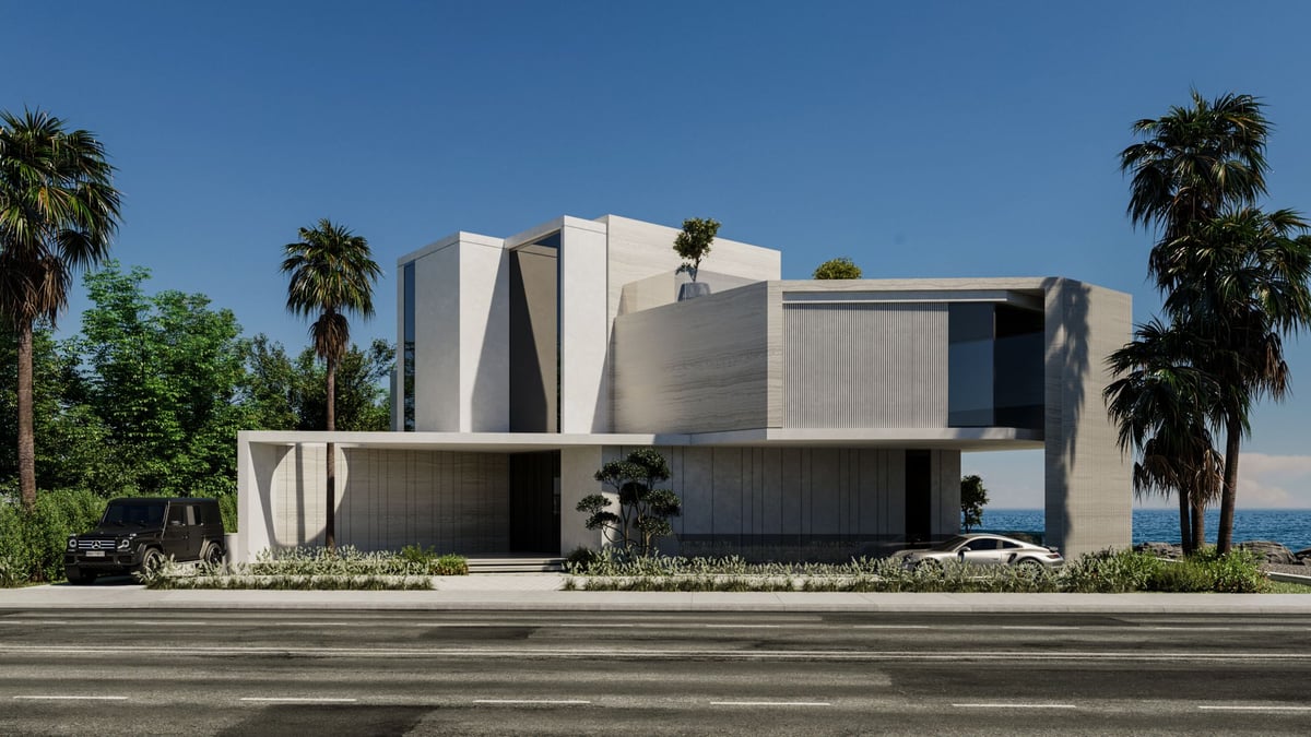 La Mer C1 — To the street the house is closed: travertine volumes, a fluted stone fin and deep shadow.