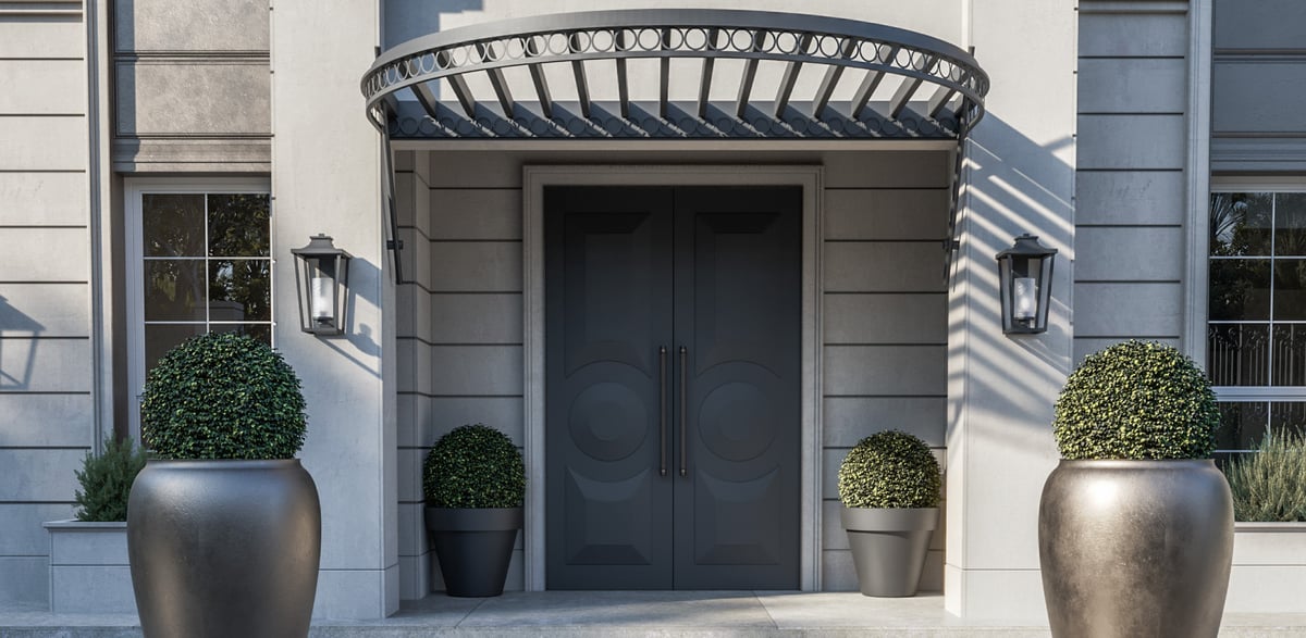 SS Residence — Open metalwork makes the entrance canopy a lighter counterpart to the masonry façade.