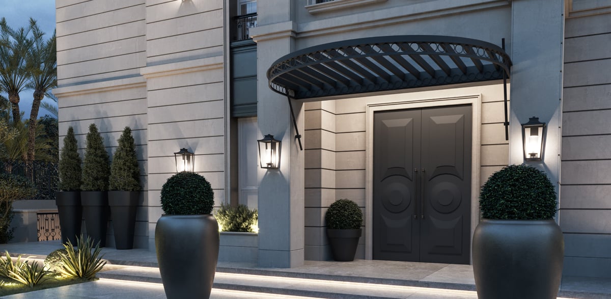 SS Residence — A curved metal canopy marks the threshold without concealing the stonework above.